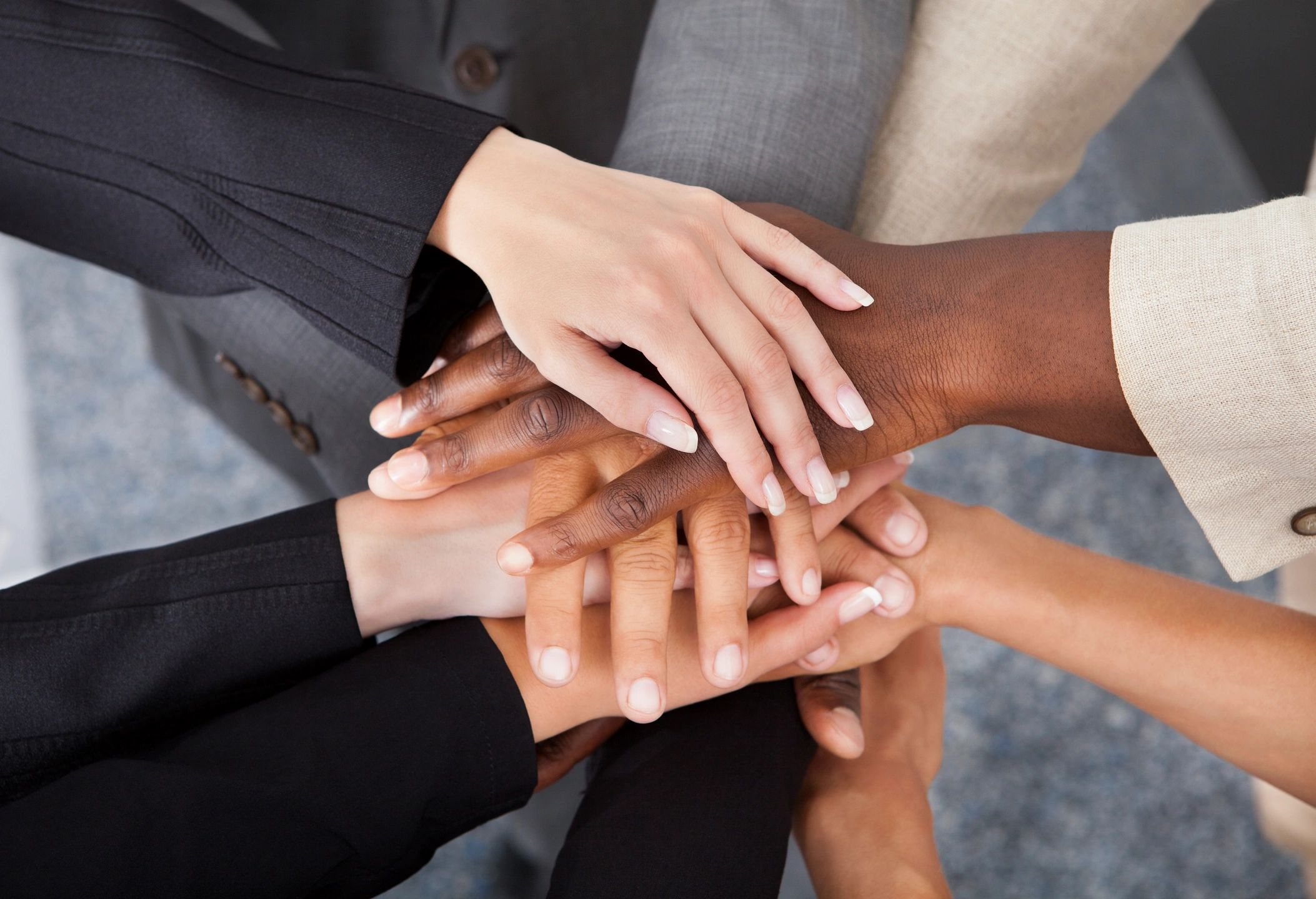 Team hands together representing unity and staffing